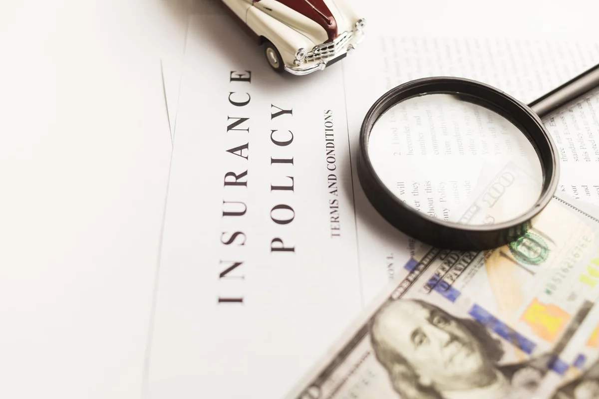 Magnifying glass on a contract, spotting the fine print in a cash offer