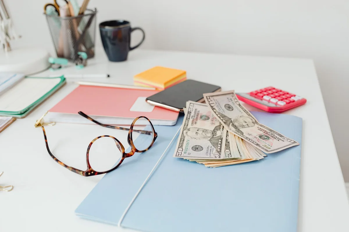 Calculator and bills showing the real costs of filing bankruptcy
