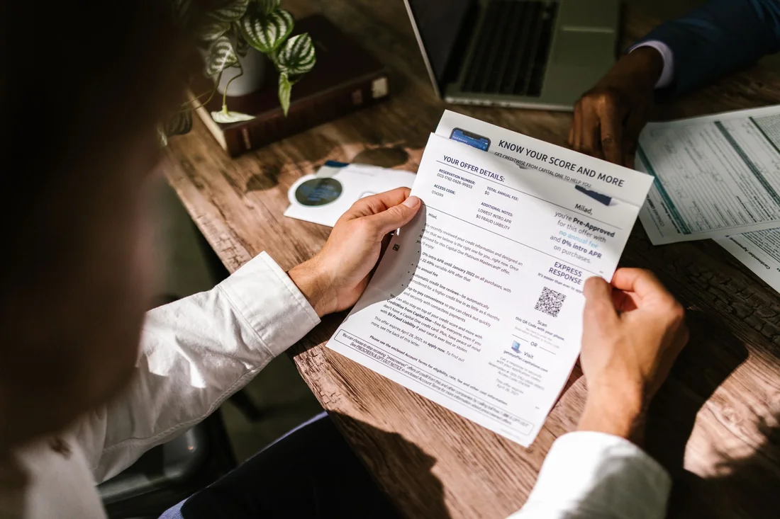 A person reading a credit report to see how long a foreclosure stays on their credit
