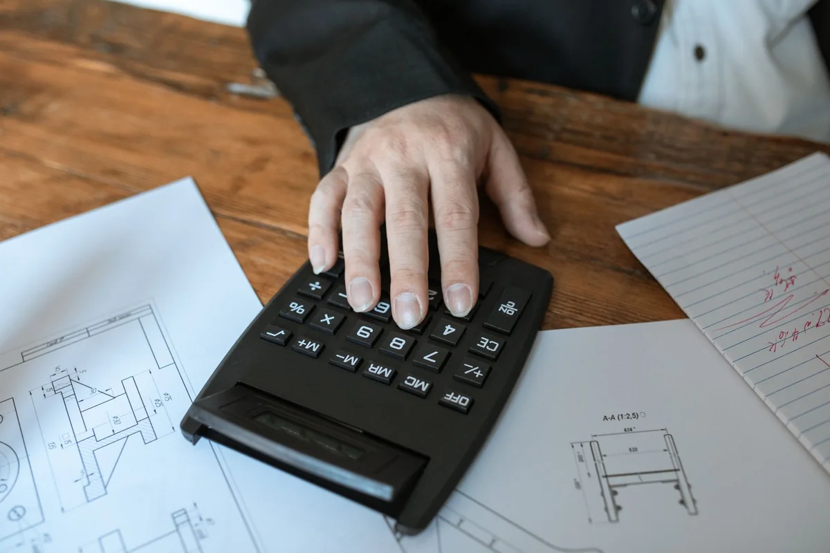 A calculator on a desk used to estimate how many points a foreclosure costs a credit score
