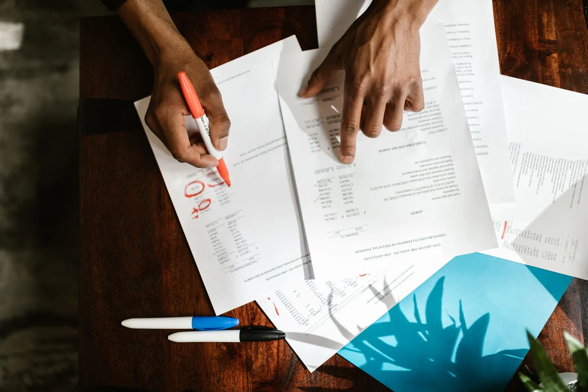 A person reviewing a credit report at a desk after a foreclosure