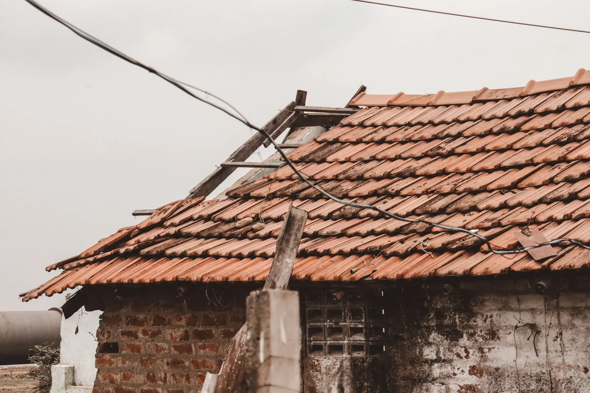 A damaged old roof on a house, a big-ticket repair that rarely returns dollar-for-dollar when selling