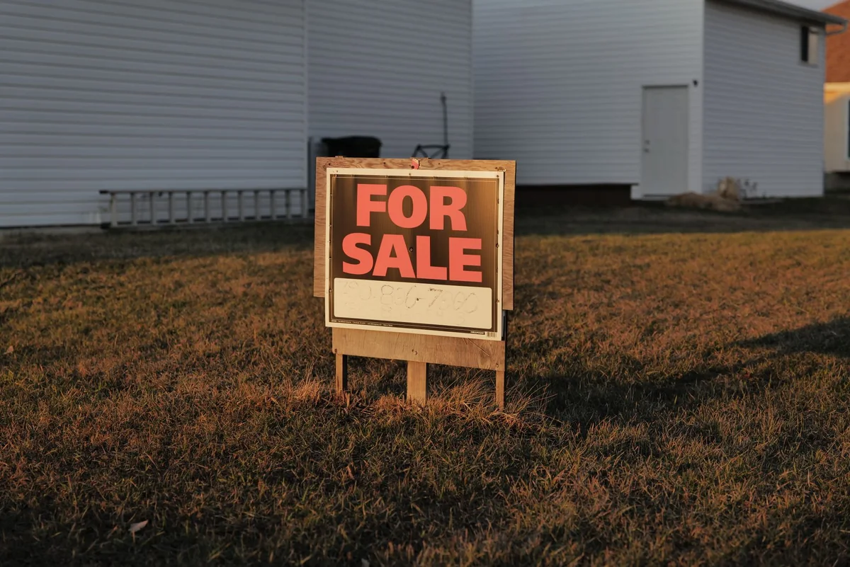 A for-sale sign in a suburban yard for a home listed without a pre-sale inspection