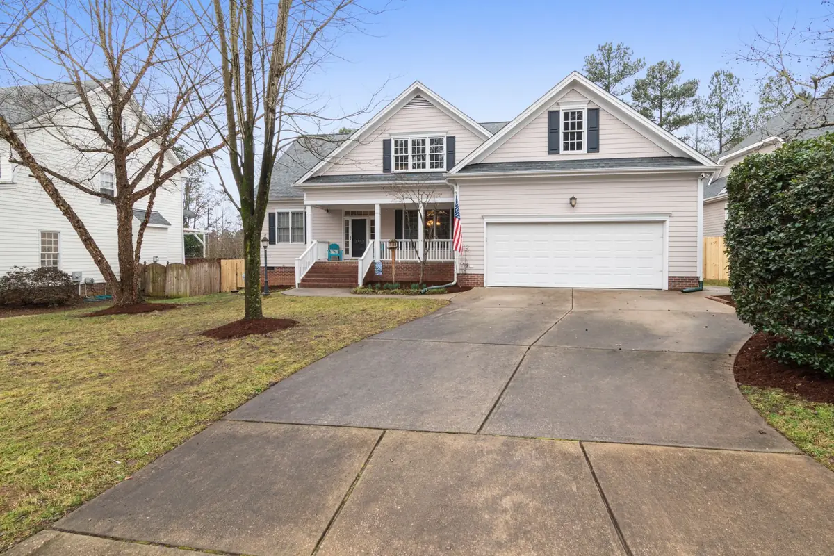 A white two-story Iowa family home with a front porch, the kind of primary residence Iowa's homestead exemption protects in bankruptcy