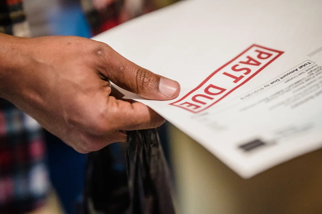 A past-due notice in hand, the kind that arrives when you can sell a house in foreclosure