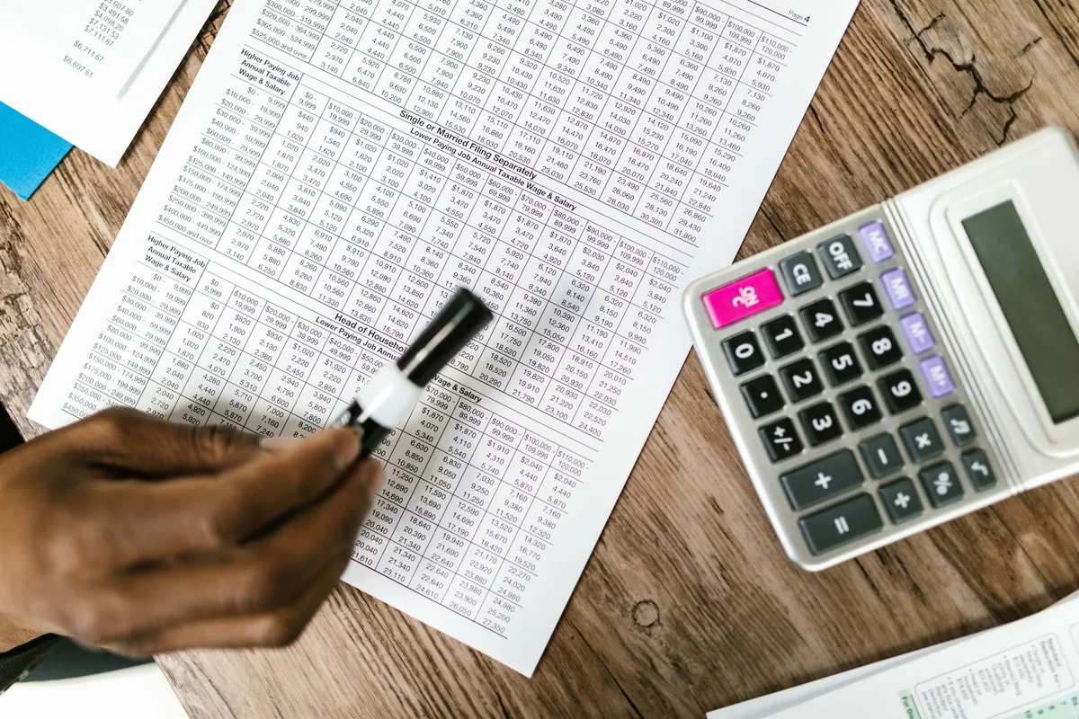 A pen resting on claim paperwork, calculating actual cash value versus replacement cost and recoverable depreciation