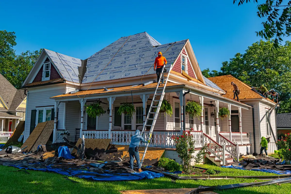 A contractor replacing a damaged roof, weighing whether to repair with insurance proceeds before selling or sell as-is