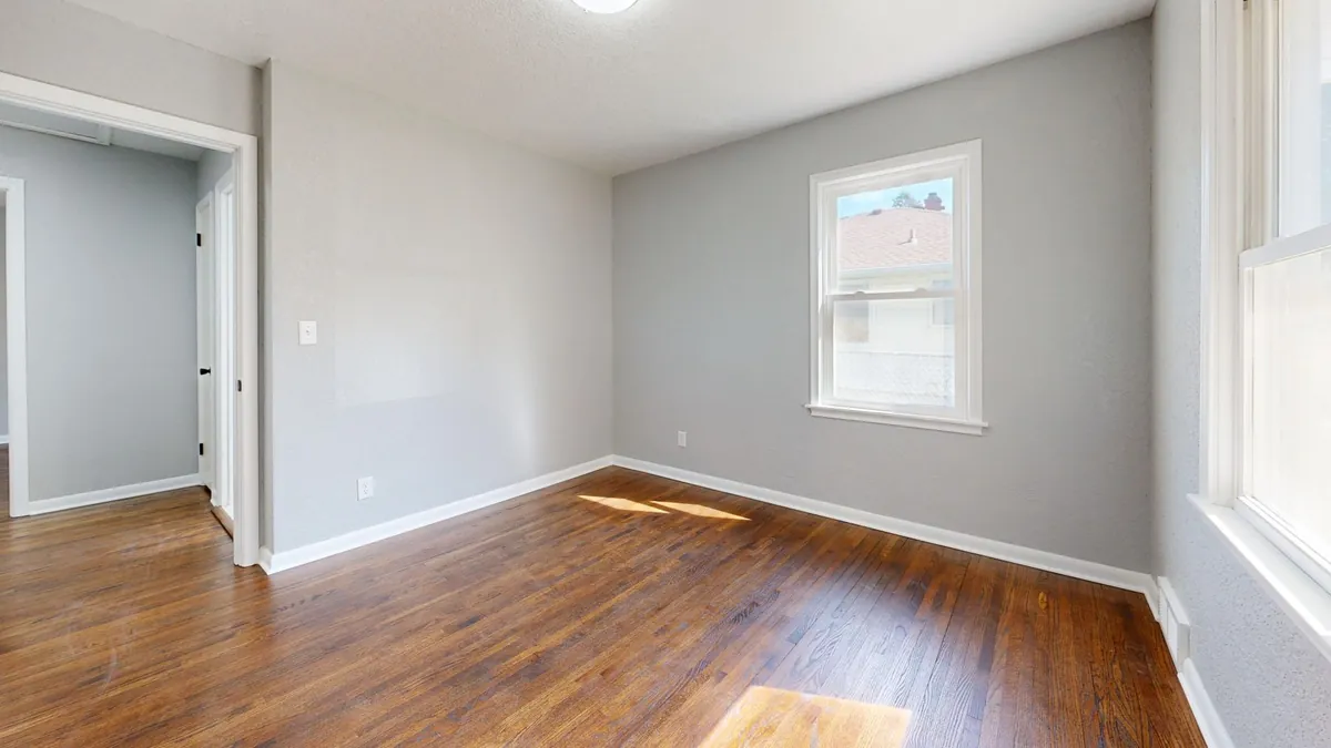 A bright empty living room in a vacant rental house ready to sell after the lease ends in Iowa