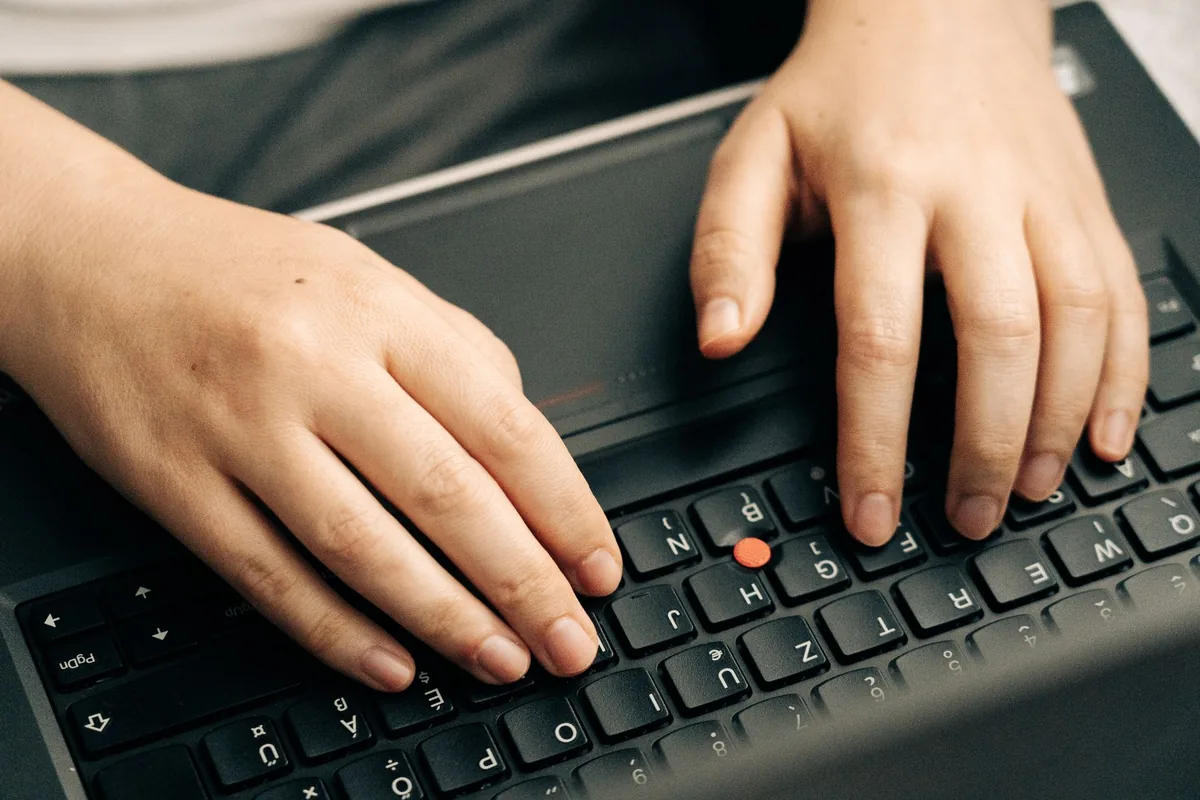 Writing a Craigslist house listing on a laptop keyboard