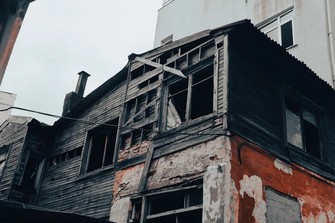 A weathered older house that needs repairs, the kind sold in poor condition in Iowa