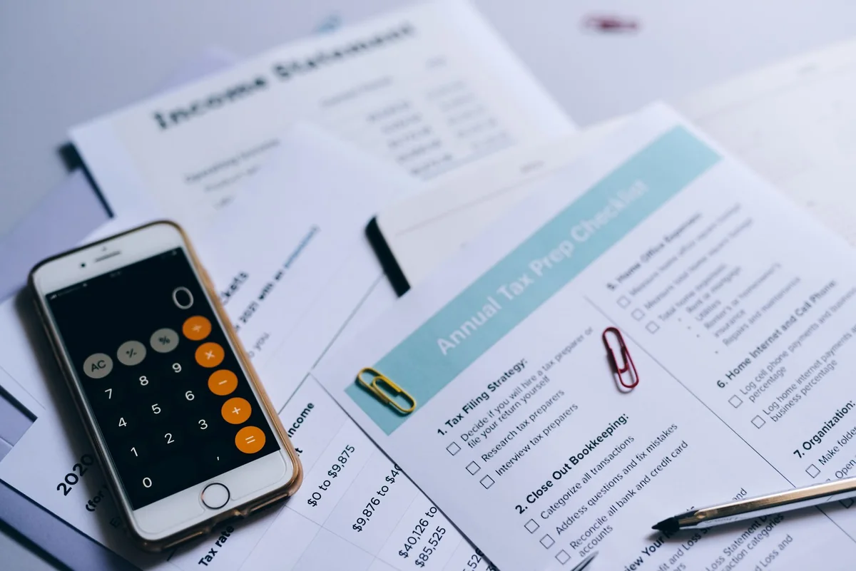 Accounting documents and a phone used to figure capital gains on a rental