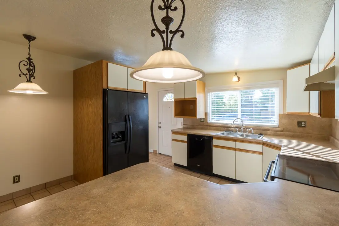 A dated kitchen a homeowner is deciding whether to fix before selling a house in Iowa
